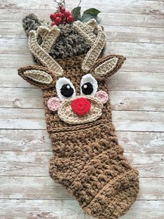 a crocheted christmas stocking with a reindeer's nose and antlers on it