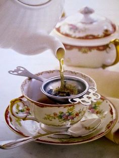 tea being poured into a cup on a saucer