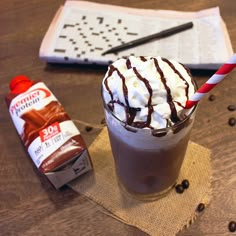 there is a drink with whipped cream and chocolate on the table