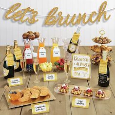 a table topped with lots of food and drinks next to a sign that says eat brunch