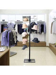 a clothing store with clothes and hats on racks