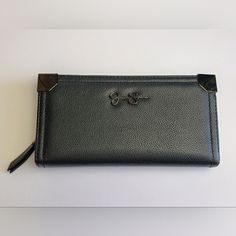 A Beautiful Organizer Wallet From The Jessica Simpson Collection. The Black Pebbled Faux Leather Material Gives Off A Sophisticated Look, With Accents Of The Brand Logo And Gunmetal Hardware Add A Touch Of Elegance. Compart - 1 Features 13 Credit Card Slots, Clear Id Window, And A Bill Slot. Compart - 2 Has 2 Sections For Bills And Receipts Divided By A Coin Zip Pocket. Measures: 8" X 4" X 1" Excellent Condition, New Without Tags. Please View All Photos I Have Listed. Thanks For Looking And Be S Black Clutch Wallet For Office, Chic Wallets With Snap Closure For Daily Use, Chic Wallets With Snap Closure, Elegant Black Wallet With Snap Closure, Black Wallet With Magnetic Closure, Trendy Black Formal Wallet, Jessica Simpson Collection, Gunmetal Hardware, Wallet Organization