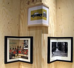 three framed photographs hang on the wall next to each other