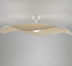 a modern light fixture with wavy lines on the ceiling