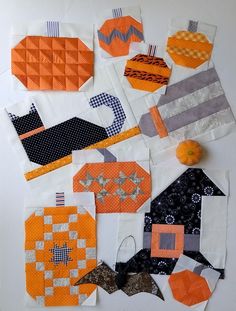 several pieces of fabric are laid out on top of each other, including oranges and grays