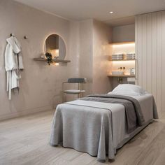 a bedroom with a bed, mirror and towels on the wall next to each other