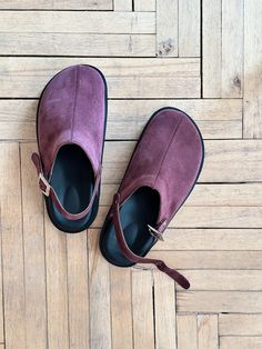 Barefoot shoes with a movable strap. You can wear these burgundy suede clogs either with a strap around the heel for better fixation, securing it around the ankle, or at the front, like mules. Crafted in suede, featuring a genuine leather lining inside. A geometric buckle serves as the main accent. Light polyurethane voluminous anatomic sole. Round toe. PRODUCT INFORMATION Upper: suede Lining: leather Sole: orthopaedic polyurethane sole Colour: burgundy * the model is undersized * every pair of shoes is handcrafted CUSTOMIZATION OPTIONS - In terms of availability, if the size you need is in stock, we can dispatch your order within 1-2 days. However, if the size is out of stock or requires a custom order, it may take up to 2 weeks to make the clogs, followed by an additional 7-14 days for s Clogs Women, Womens Clogs And Mules, Clogs And Mules, Suede Clogs, Orthopedic Shoes, Purple Suede, Barefoot Shoes, Clogs Shoes, Womens Clogs