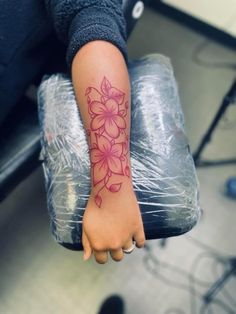 a person with a flower tattoo on their arm