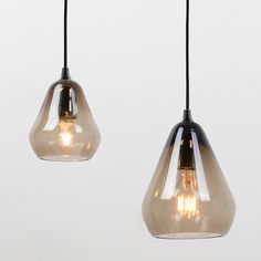 two glass pendant lights hanging from a ceiling