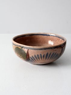 a brown and black bowl sitting on top of a table