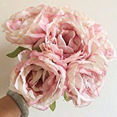 a bouquet of pink flowers sitting on top of a table