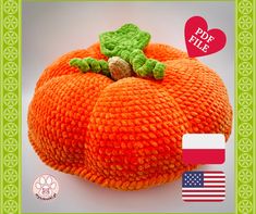 an orange stuffed pumpkin sitting on top of a green frame with the american flag in the background