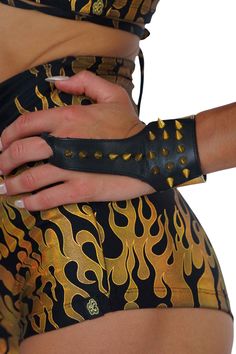 The black and gold leather spike cuff bracelets are giving new meaning to hand armor! This jewelry accessory is a cross between gold fingerless gloves and a leather cuff bracelet. Inspired by punk and glam rock aesthetics, and designed to make a statement, these spike bracelet cuffs are perfect for everything from festival outfits to going out Friday night. FEATURES: Made with black, and gold foiled sheepskin leather Finger loop Gold Spike detailing Adjustable snaps at the wrist Ethically handma Hand Armor, Gloves Dress, Bracelet Cuffs, Punk Glam, Spike Bracelet, Bracelet Inspired, Arm Cuff, Leather Cuffs Bracelet, Glam Rock