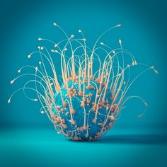 a blue vase filled with lots of white and orange spiky plants on top of a blue surface