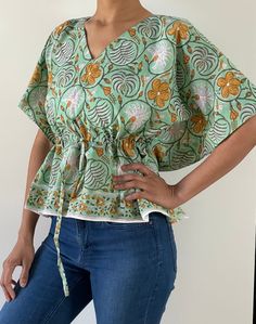 Blouses are made of Indian hand block cotton fabric in beautiful prints. Total 6 prints available, choose your option from drop down menu!  It is made to fit few sizes of 2 to 12 easily, please check measurements!  Great for work/outings/vacations.  Length - 21.5" Bust - fits up to 43" of bust all around.  Waist - fits up to 37" of waist all around. My bust is 36" and waist is 28" for reference. Caftan blouse has drawstring waist for a cinched waist look. You can adjust accordingly!! If you like Green Printed V-neck Top, Spring Batik Print Relaxed Fit Tops, Spring Batik Print Relaxed Tops, Cotton Block Print Relaxed Fit Top, Bohemian Cotton V-neck Top, Cotton Block Print Tops With Relaxed Fit, Pattern Print Cotton Short Sleeve Top, Cotton Short Sleeve Top With Pattern Prints, Relaxed Fit Cotton Tops With Batik Print