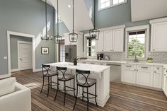 a large open concept kitchen with white cabinets and wood flooring is featured in this rendering