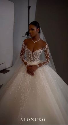 a woman in a wedding dress posing for the camera