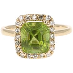 This beautiful ring has a Emerald Cut Peridot in the center that weighs 3.42 carats. The ring is surrounded by a gorgeous halo of 21 Round Cut Diamonds that weigh 0.31 carats. The total carat weight of the ring is 3.73 carats. The setting is crafted in 14K Yellow Gold. This ring is a size 7 and re-sizing is available at no additional charge. Gold Peridot Ring, Rings Multiple, Yellow Gold Cocktail Ring, Peridot Jewelry, Vintage Fine Jewelry, Vintage Inspired Jewelry, Gold Cocktail Ring, Gold Cocktail, Ring Emerald