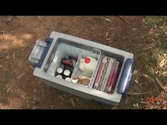 an open cooler sitting on top of a dirt field