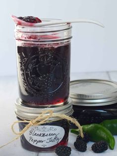 blackberry pepper jelly in a mason jar with fresh blackberries