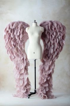 a mannequin with pink feathers on it