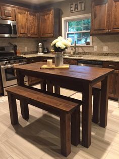 a kitchen table with two benches in front of it