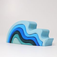 two blue and green wavy shapes on a white surface