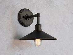 an old fashioned wall light on a concrete wall