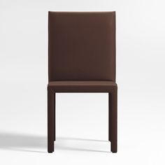 a brown leather chair sitting on top of a white floor