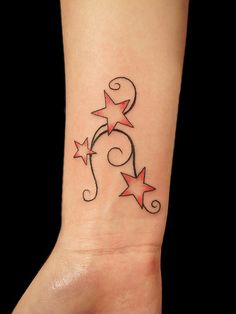 a person with a tattoo on their foot that has stars and swirls on it