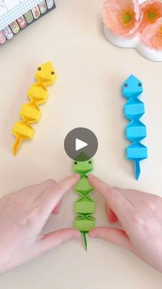 someone is making origami seahorses out of paper