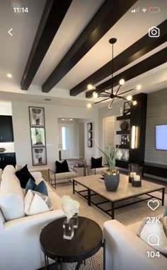 a living room filled with furniture and a flat screen tv mounted to the wall above it