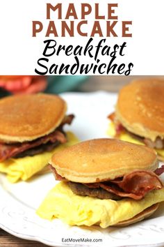 three pancakes with bacon and eggs on them sitting on a white plate next to a pink flower