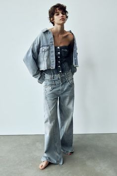 Lapel collar jacket with long cuffed sleeves. Pockets at front and sleeve. Loop detail at back. Unfinished hem. Front metal button closure. Double Waistband Jeans, Denim 2023, Photo Mannequin, Zara Wide Leg Jeans, High Rise Blue Jeans, Denim Wear, Cropped Denim Jacket, Button Fly Jeans, Ripped Denim