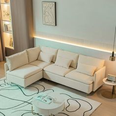 a living room with a white couch and coffee table