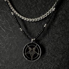 Embrace bold style with our striking Baphomet necklace, featuring a blend of materials and design elements that stand out. This unique piece showcases a durable stainless steel curb chain paired with black glass and stainless steel beads, creating a layered look that is both edgy and sophisticated. At its center hangs an antiqued Baphomet pendant. The combination of the polished stainless steel chain and the intricate beadwork enhances the overall aesthetic, making it a perfect accessory for tho Alternative Style Black Metal Jewelry, Black Alternative Style Jewelry With Chain, Alternative Black Chain Jewelry, Alternative Style Black Chain Jewelry, Black Alternative Style Chain Jewelry, Black Stainless Steel Jewelry For Streetwear, Alternative Style Chain Jewelry For Streetwear, Punk Style Black Necklace For Streetwear, Edgy Black Necklace For Streetwear