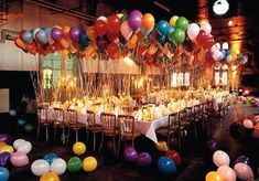 a long table with many balloons on it