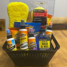 a basket filled with cleaning products on top of a wooden table