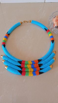 African Statement Necklace, African Beaded Layered Necklace, African Jewelry, Sky Blue Necklace, Tri Blue Multi-strand Necklace With Tiny Beads, Blue Beaded Chain Bib Necklaces, Blue Beaded Chain Bib Necklace With Round Beads, Blue Bib Necklace With Beaded Chain And Round Beads, Blue Round Beaded Chain Bib Necklace, Handmade Blue Multi-strand Necklace, Light Blue Beaded Necklaces For Jewelry Making, Blue Multi-strand Necklace With Spacer Beads, Blue Beaded Bib Necklace With Round Beads