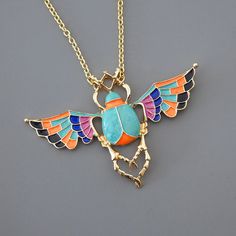 "Vintage Jewelry - Scarab Necklace - Gold Necklace - Vintage Inspired Necklace - Turquoise Necklace - Colorful Necklace - Scarab Jewelry This is such an awesome necklace! Beautiful colors.  A gorgeous large scarab beetle bug is embellished with colorful enamel of turquoise, orange,black and purple.  The pendant hangs from a gold plated chain. Chloe says, Wear it and feel fabulous!\" The pendant is  2\" tall and 3\" wide.  You can choose the length you would like at checkout. Thanks for visiting Colorful Metal Necklace As A Gift, Colorful Metal Necklaces For Gifts, Colorful Metal Necklaces As Gift, Colorful Pendant Jewelry As A Gift, Colorful Metal Jewelry For Gifts, Colorful Metal Jewelry As A Gift, Colorful Metal Jewelry As Gift, Colorful Metal Jewelry Gift, Colorful Costume Jewelry Gift