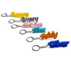 three key chains with the word adver written in different colors and letters attached to them