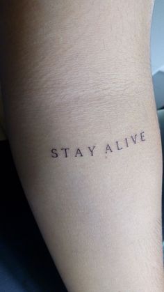 the word stay alive is written on someone's leg