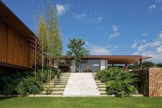 the house is surrounded by greenery and brick steps leading up to it's entrance