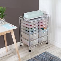 a baby changing table with many drawers on it and a potted plant in the corner