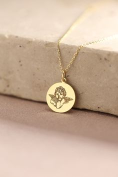 Gold Cupid Pendant -  Baby Angel Gold Necklace ● Material of pendant: Solid Gold 14k ( REAL GOLD ) ● Metal Stamp: 14k ( REAL GOLD ) ● The pendant is available in 5 sizes: - 12,7 mm / 0.5 inches (Diameter) - 14,0 mm / 0,55 inches ( Diameter ) In the photos - 15,3 mm / 0.6 inches ( Diameter ) - 16,5 mm / 0,65 inches ( Diameter ) - 19,1 mm / 0,75 inches ( Diameter ) ( In the photos the size is 14mm / 0.55 inches Diameter ) ( Jump Ring inner diameter: 4 mm ) ● Material of chain: Solid gold 14k ( REA Handmade Round Charm Necklace For Birthday, Handmade Round Charm Necklaces For Birthday, Cute Yellow Gold Necklace For Gift, Cute Necklace For Mother's Day, Cute Round Necklaces For Mother's Day, Personalized Cute Necklaces, Cute Mother's Day Necklace, Cute Personalized Round Necklaces, Cupid Necklace