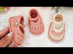 two crocheted baby shoes sitting next to each other