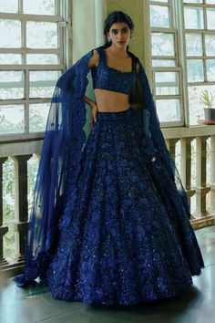 Navy blue lehenga highlighted with heavy floral embroidery. Comes with chanderi blouse and organza dupatta. 
Component: 3
Embroidered
Neckline: Square
Sleeve Length: Sleeveless
Fabric: Organza, Chanderi
Color: Blue
Embroidered scallop edged blouse and dupatta
Notched square neckline
Tie-up with tassels at the back
Closure:
Blouse: Hooks at the back
Lehenga: Drawstring with tassels at the waist - Aza Fashions Lehenga Blue, Royal Blue Lehenga, Navy Blue Lehenga, Orang India, Sangeet Outfit, Reception Outfit, Blue Organza, Organza Lehenga, Lehenga Designs Simple