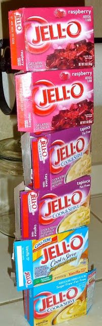 three boxes of jello are stacked on top of each other in front of a microwave