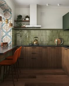 an image of a kitchen setting with green tiles on the wall and wood flooring