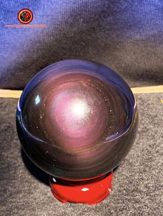 a purple ball sitting on top of a red object